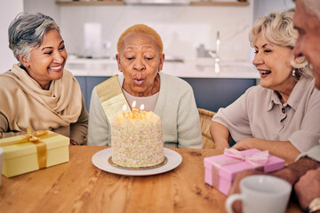 Senior women, friends and candles on birthday cake for a celebration, party and social gathering....