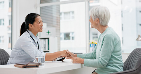 Fototapeta premium Doctor handshake, senior woman and healthcare with thank you in a hospital for medical care. Elderly consultation, smile and insurance conversation with women in a clinic office for retirement advice