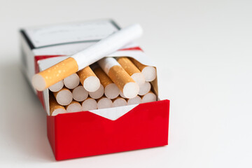 Pack full of filtered cigarettes on white isolated background.