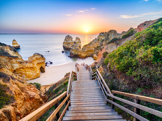 Boardwalk and Stairs to Camilo Beach at Sunrise..Camilo Beach,Praia do Camilo,Natural Cliff Formation and Beach Cove.Lagos,Algarve,Portugal,Europe