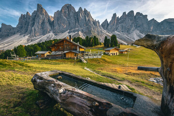 Wooden well and woodem houses in the Dolomites, Italy