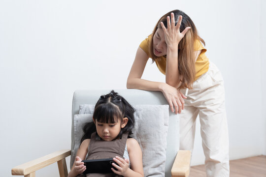 Asian mother feeling worried her daughter game addiction.