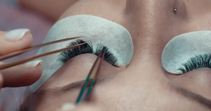 Eyelash extension test with brush on female model. Checking procedure for lashes , close up