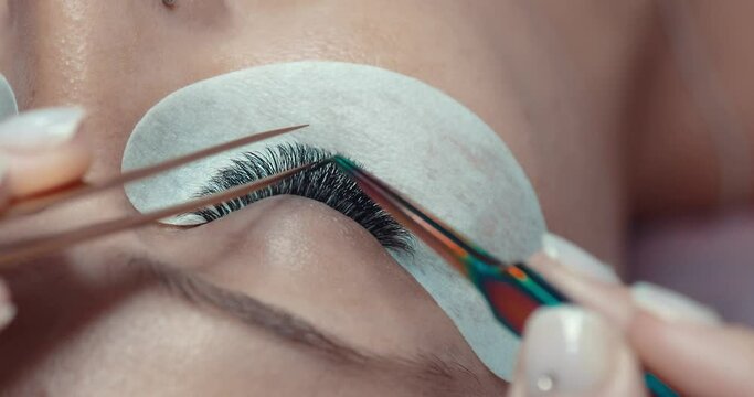 Eyelash extension test with brush on female model. Checking procedure for lashes , close up