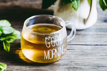 Tasse de thé à la menthe et menthe poivrée fraîche fait-maison et feuilles