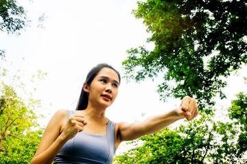 Recreation young asian woman exercising in the park : Beautiful asian woman warming up practicing...