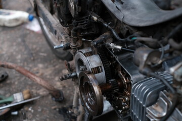 Motorcycle mechanics are assembling the motorcycle engine clutch assembly and maintenance.