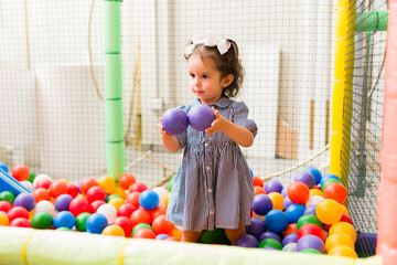 Fototapeta na wymiar Caucasian child having fun playing in the ball pit
