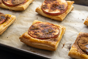 Puff pastry apple tarts  on black background.food concept. dessert. bakery
