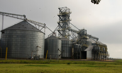 dtina silos, and grains in a field. agro-export industry