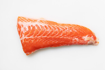 Tail of salmon fillet on white cutting board for delicious salmon steak.