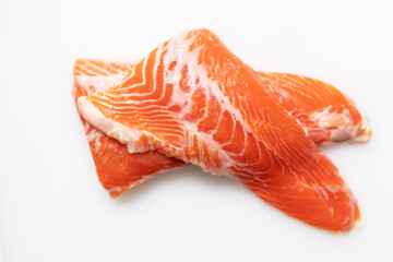 Tail of salmon fillet on white cutting board for delicious salmon steak.