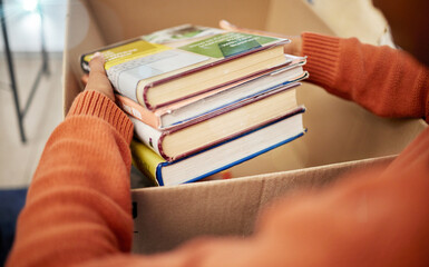 Donation, charity and woman hands with books in box for nonprofit and cardboard container at home....