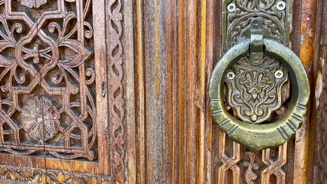 Wooden carving patterns on the doors of a Muslim mosque