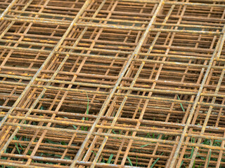 Close-up of reinforcing steel mesh. House construction. Building site materials. Foundation structure