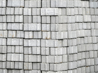 Close-up of pile of builders grey bricks. House construction. Building site materials. Foundation...