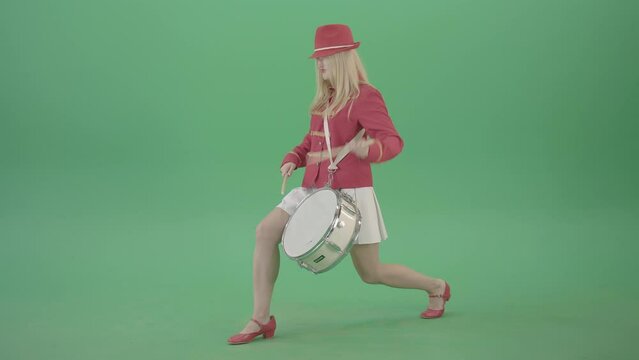 Blondie is ready for adventure making beats on snare drum isolated on Green Screen - 4K Video Footage