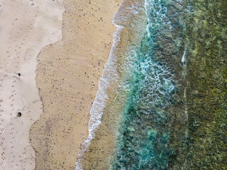 Fototapeta na wymiar Lombok, Indonesia, Beach ocean drone aerial view landscape at Tanjung Ann beach area. Lombok is an island in West Nusa Tenggara province, Indonesia.