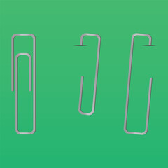 Metal rectangle paper clip isolated and attached to paper