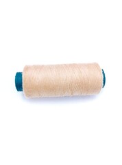 Beige color sewing thread isolated on white background