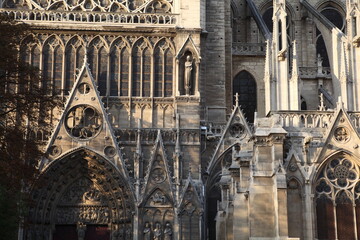 External front view of the Notre Dame Cathedral against blue sky - Paris France