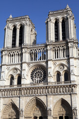External front view of the Notre Dame Cathedral against blue sky - Paris France