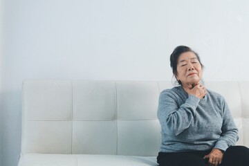 Fototapeta premium Elderly Asian woman allergy pills and a cough.