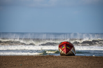 beach shore with waves and fishing boat