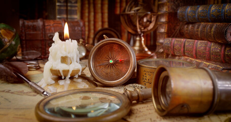 Vintage style travel and adventure. Vintage old compass and other vintage items on the table.