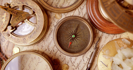 Fototapeta na wymiar Vintage style travel and adventure. Vintage old compass and other vintage items on the table.