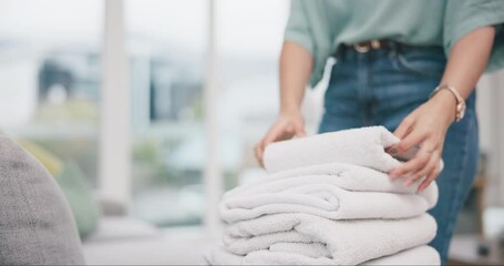 Laundry, hands and woman packing towel and cleaning in a home living room doing housework for hygiene. Sorting, service and young tidy person or cleaner working on household task in a lounge
