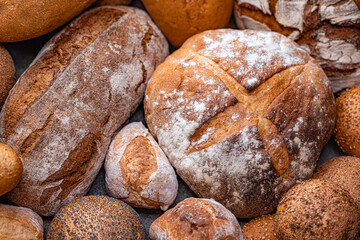Freshly baked natural bread is on the kitchen table. - 636992252