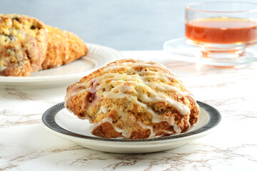 raspberry lemon scone on a plate with tea