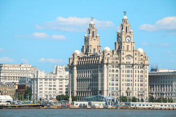 View of the iconic Royal Liver Building in Liverpool from River Mersey, with the Liver Birds, Bella and Bertie crowning the famous piece of architecture, guarding the city