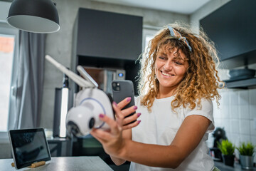 adult caucasian woman adjust prepare home surveillance security camera