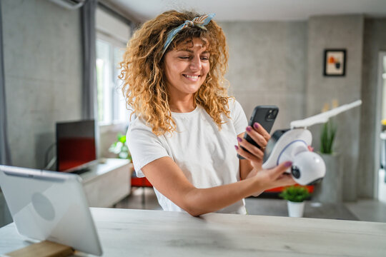 adult caucasian woman adjust prepare home surveillance security camera