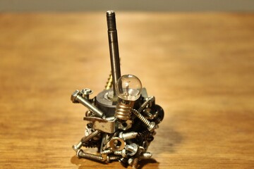 light bulbs, screws, washer and magnet on the table