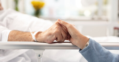 Hospital bed, support and senior couple holding hands, trust or comfort sick partner with healthcare problem. Bedroom, marriage love or elderly people care for mental health patient with medical risk - obrazy, fototapety, plakaty