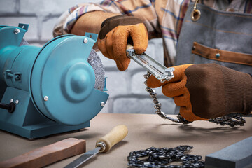  man sharpening a chainsaw chain.