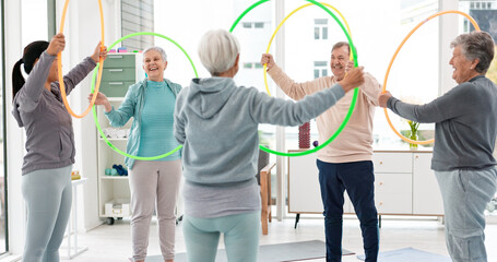 Fitness, senior and people with hula hoop at the gym for training, workout and health in retirement. Happy, together and a group of elderly friends with a coach and gear for an exercise class © Felix/peopleimages.com