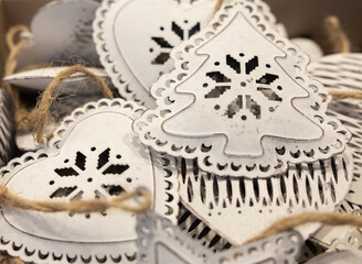 Christmas metal toys in the form of Christmas trees, hearts with carved middles are sold in the...