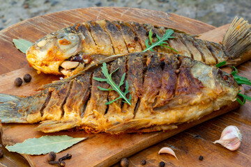 Fried appetizing fish on barbecue, picnic food close-up