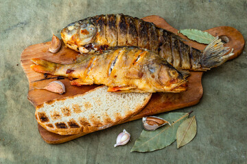 Fried appetizing fish on barbecue, picnic food close-up
