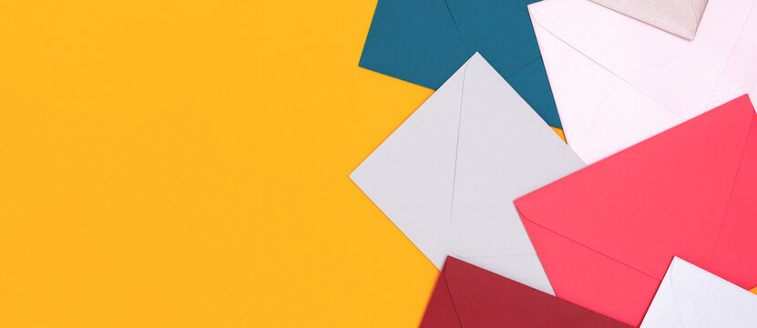 Banner with envelopes scattered on a yellow background. Creative concept with copy space.