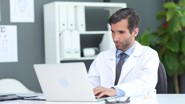 Doctor speaks with patient using laptop online