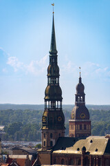 Obraz premium Photo of the two most important bell towers in the city of Riga on a sunny day.