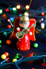 Wooden angel with guitar and christmas lights