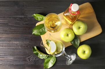 Flat lay composition with delicious apple cider on wooden table, space for text