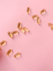 Omega-3 capsules on a pink background. In the modern world, it is important to monitor the state of health and take the necessary supplements.