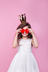 Adorable little girl kid cover eyes red hearts on pink background